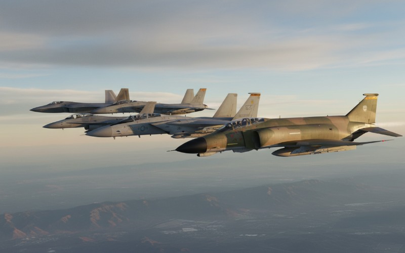 Formation of multi-generation fighter jets illustrating design evolution from fourth to fifth generation airframes